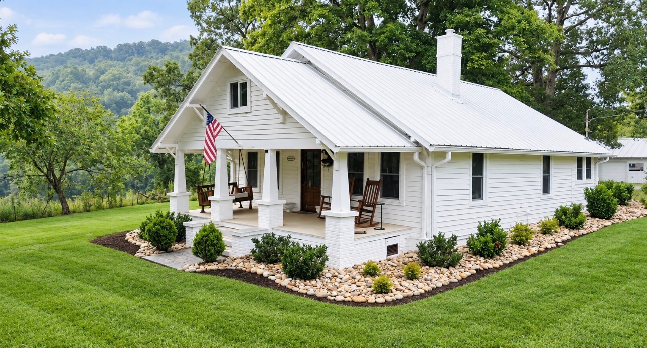 The white farmhouse at Knoxville Farm with a wide front porch and green lawn